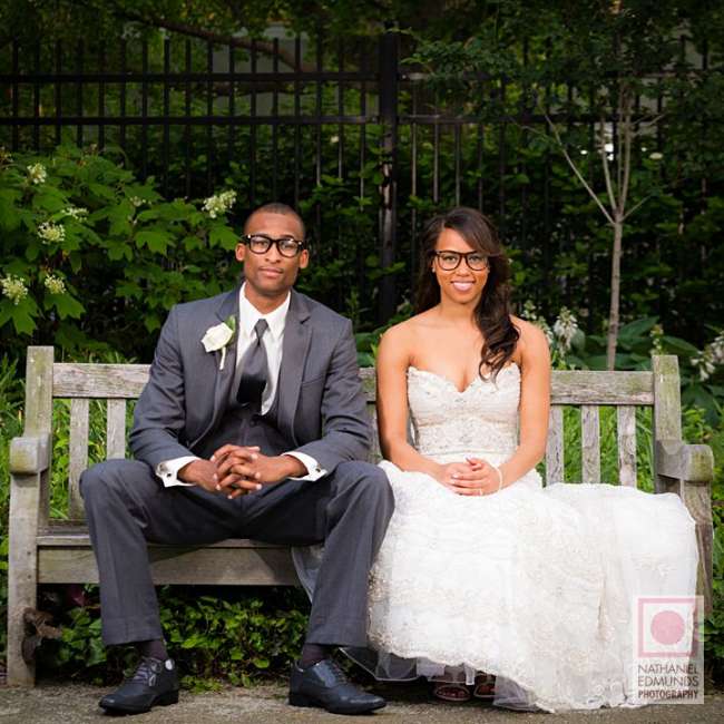 Bride and groom seated on bench