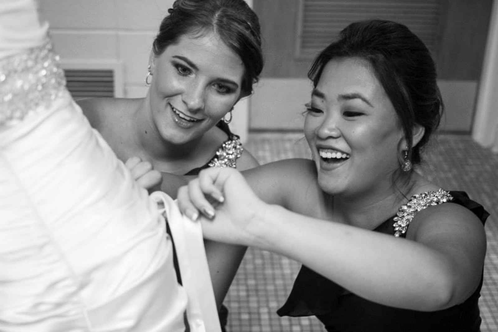 bridesmaids helping bride