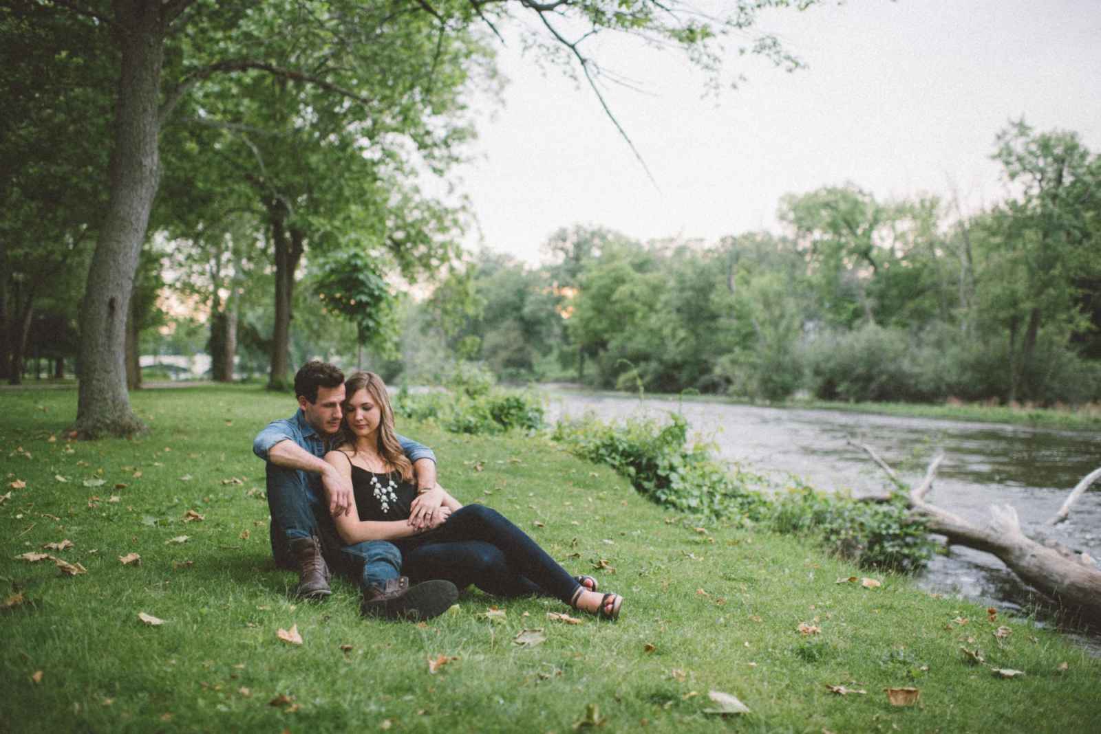 couple posing by river