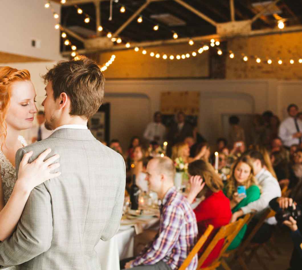 couple dancing in front of guests