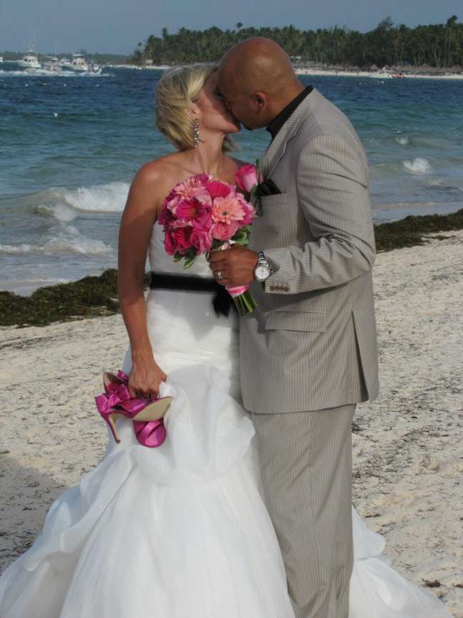 Couple kisses while strolling on beach