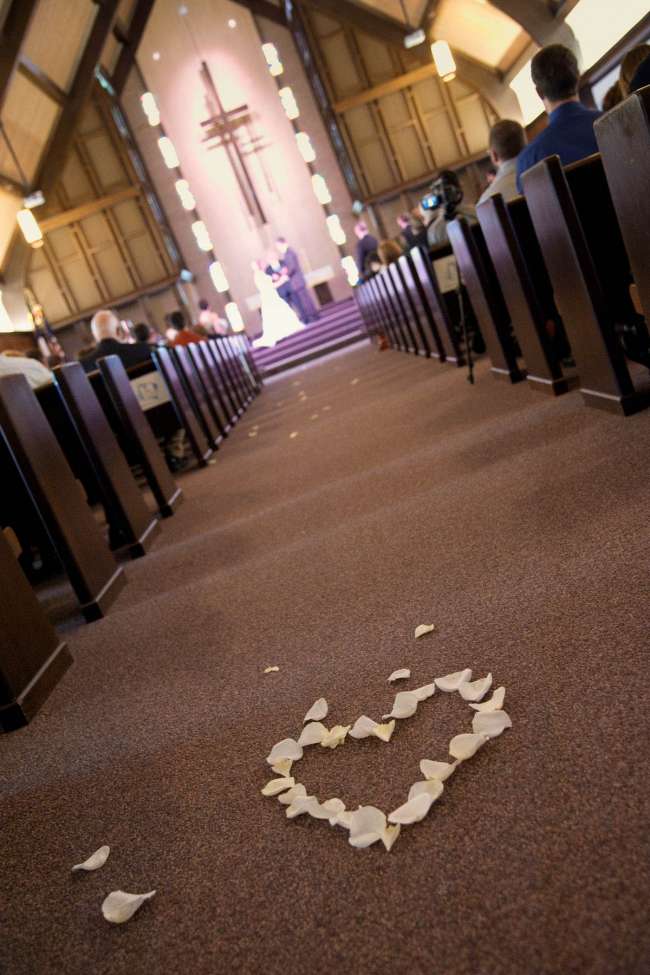 Heart-Shaped White Rose Petals in Aisle