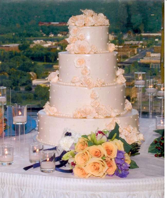 Four tiered wedding cake with flowers
