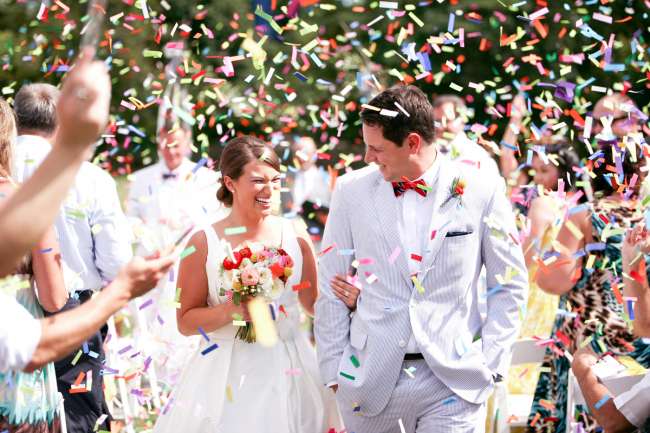 Bride & Groom Walking Through Confetti