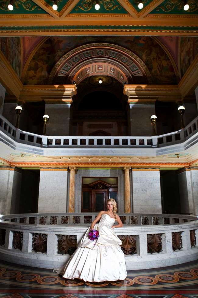Bride Standing with Purple Bouquet in Courthouse
