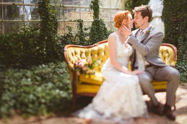 Bride & Groom on Couch in Garden