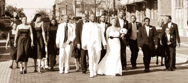 Wedding Party Walks Behind the Bride & Groom