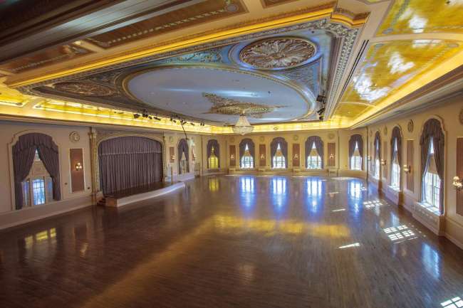 Gleaminag Ballroom dance floor with crystal chandelier and stage