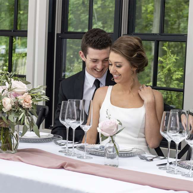 Wedding couple at head table in the venue.